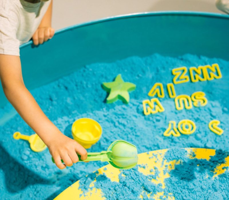 child-plays-with-kinetic-sand-art-therapy-relieving-stress-tension-tactile-sensations-creativity-pleasure-development-fine-motor-skills-concentration-attention